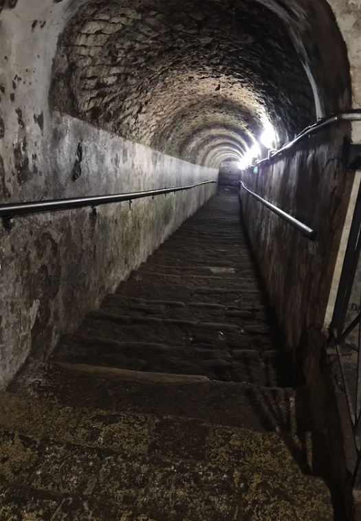 A lamp-lit tunnel below Naples